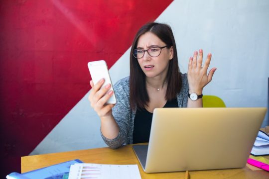Wellbeing: woman stressed looking at instant messaging